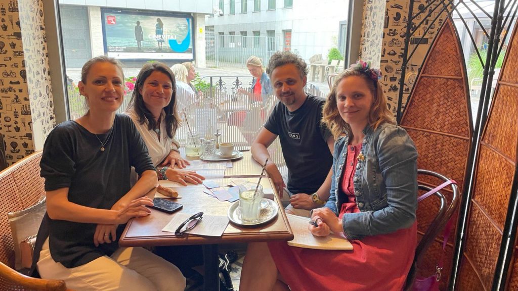 The Circa team meeting around a café table