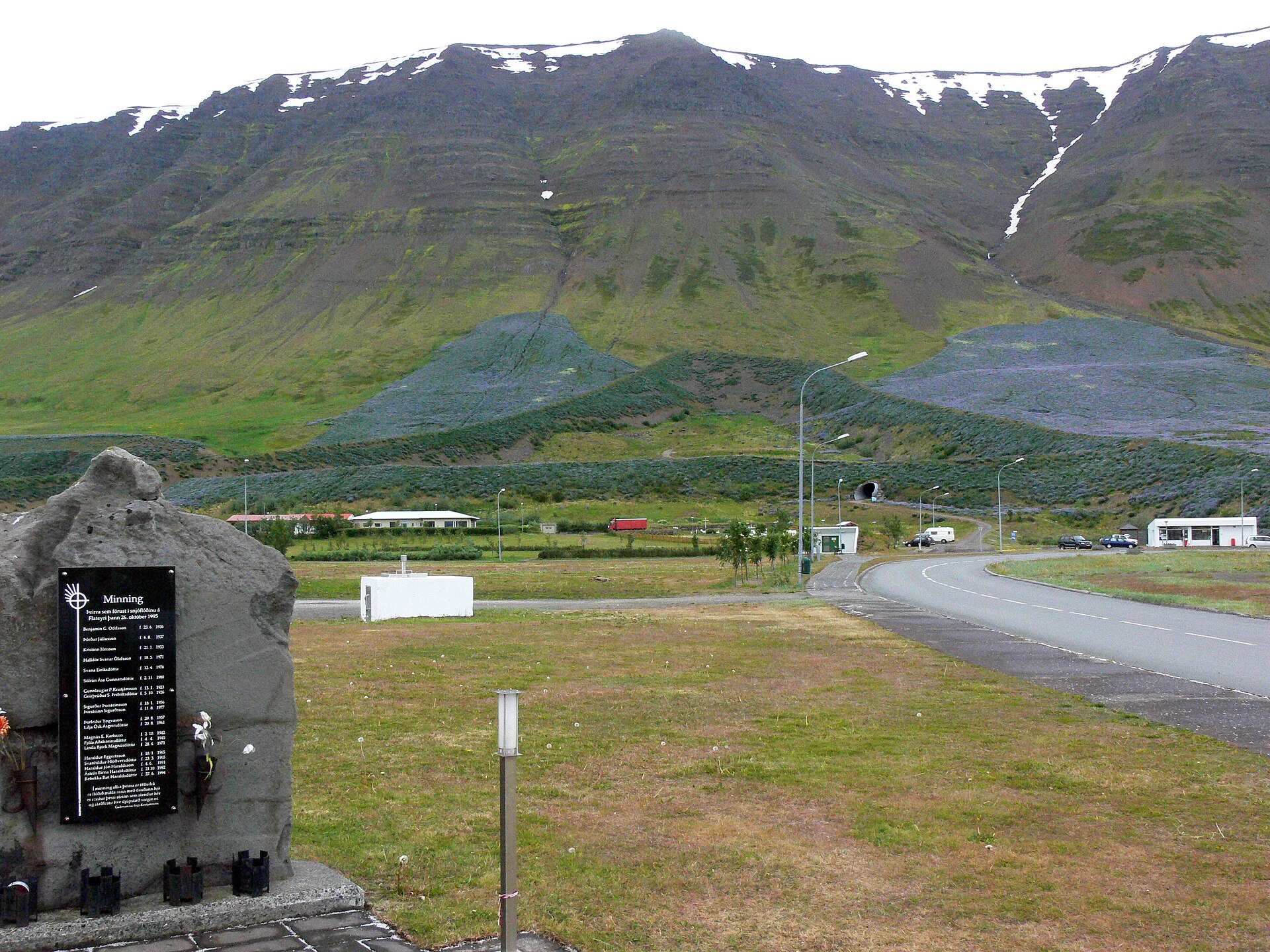 Flateyri village beneath a green mountain in Iceland's Westfjords