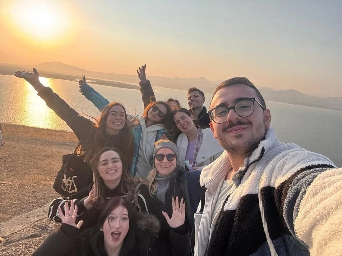 Participants by a lake at sunset in Armenia