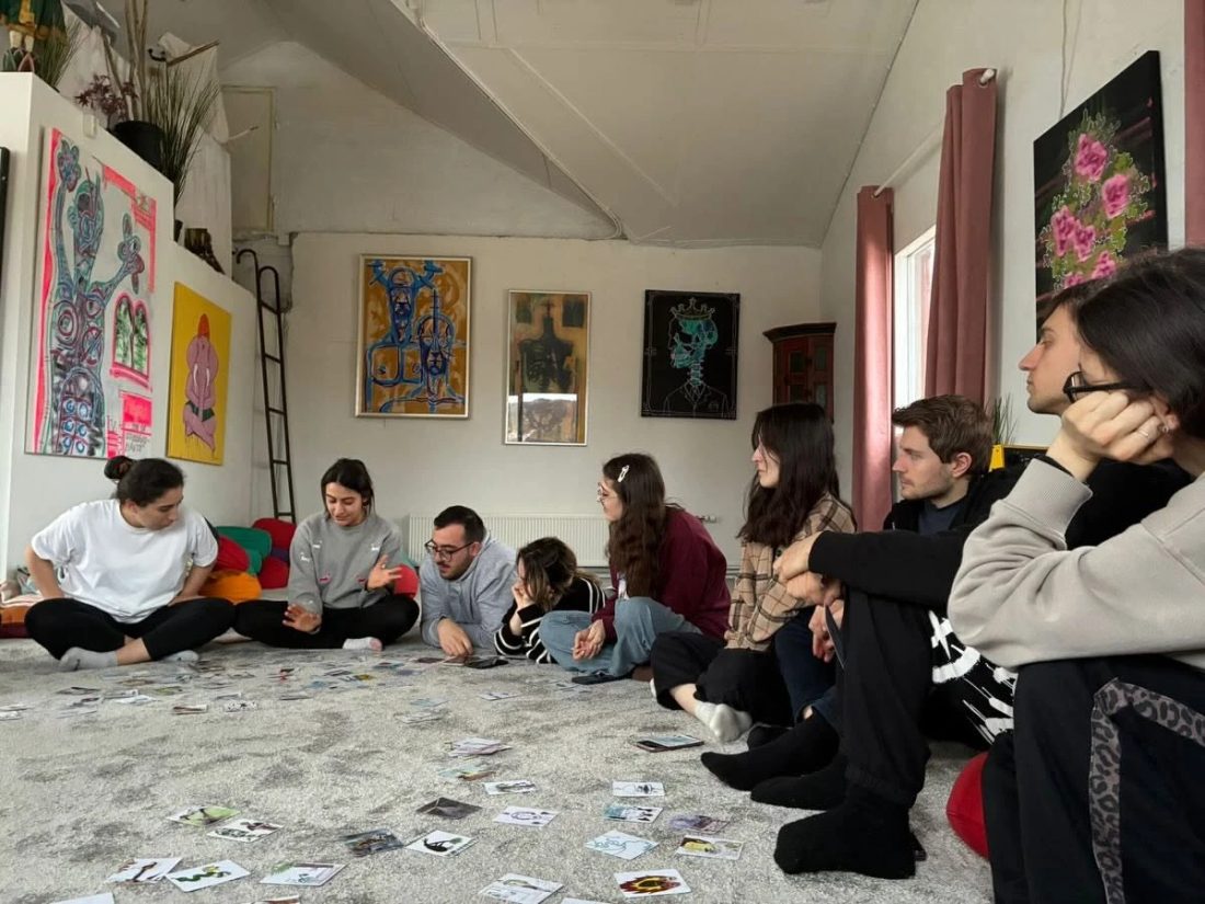 A group session using association cards spread across the floor
