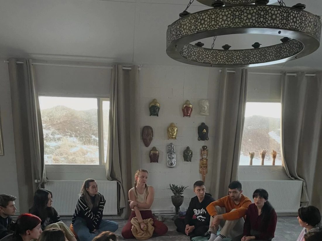 Participants sitting in a reflection circle on meditation cushions